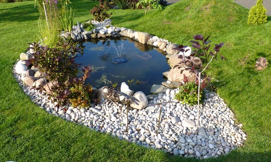 Little solar floating fountain in the pond.