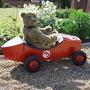One of my Bears called Beau in his car in my front Garden